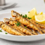 Deliziose alici croccanti cotte nella friggitrice ad aria, perfette per un antipasto gustoso.