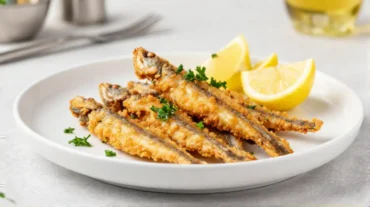 Deliziose alici croccanti cotte nella friggitrice ad aria, perfette per un antipasto gustoso.